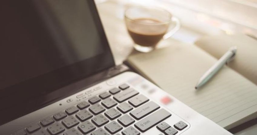 Laptop and coffee business layout